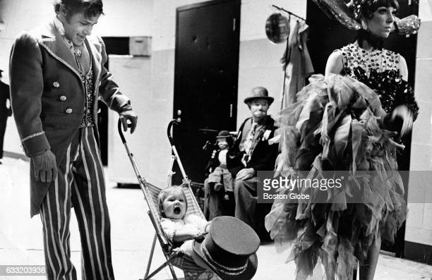 BOSTON, MA - MAY 21: Daughter Kathie, 1, holds the hat while trapeze artists Don and Alicia Martinez wait backstage to perform at the Ringling Bros. and Barnum & Bailey Circus at Boston Garden, May 21, 1974. (Photo by Ted Dully/The Boston Globe via Getty Images)